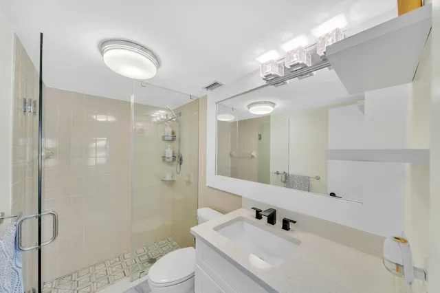 a bathroom with a sink a shower a mirror and a shower