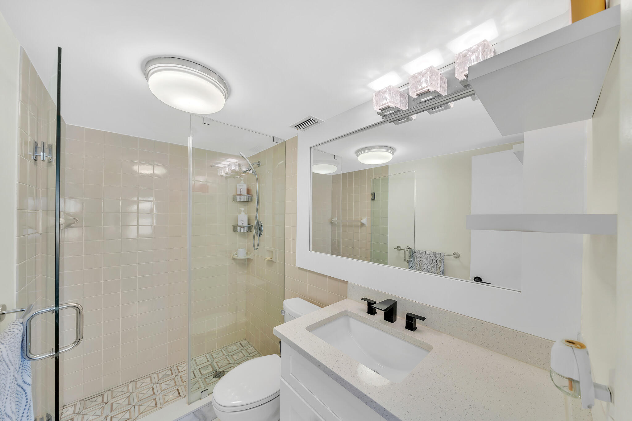 711 Northeast Harbour Terrace, Unit 3090 Boca Raton, FL 33431 - Photo 31 of 53 a bathroom with a sink a toilet and shower