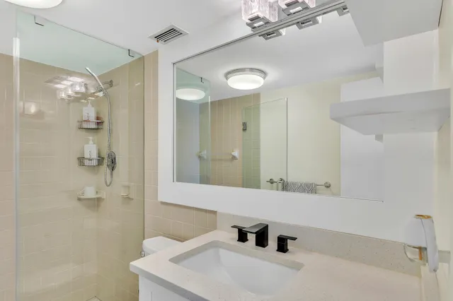 a en suite bathroom with a toilet sink and shower