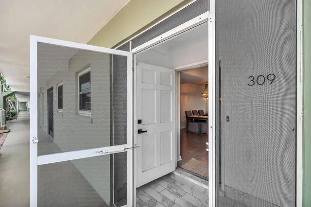 a kitchen with stainless steel appliances kitchen island granite countertop a stove and a sink