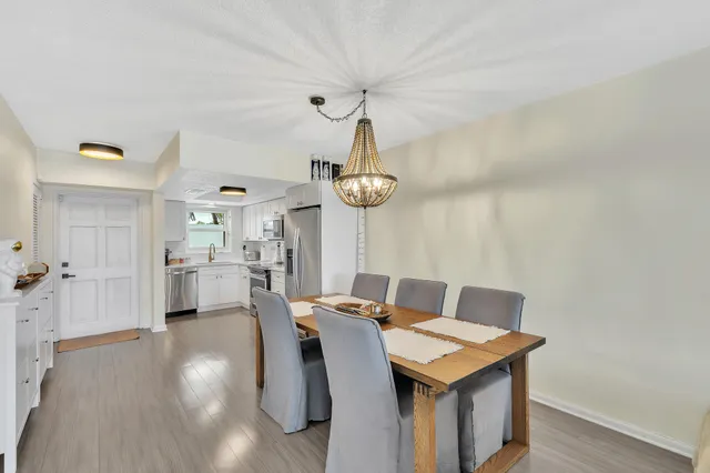 a kitchen with stainless steel appliances granite countertop a sink a stove a microwave and wooden cabinets