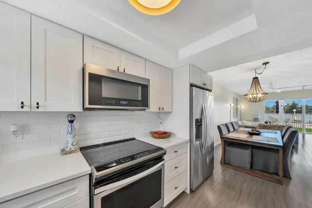 a kitchen with cabinets and wooden floor