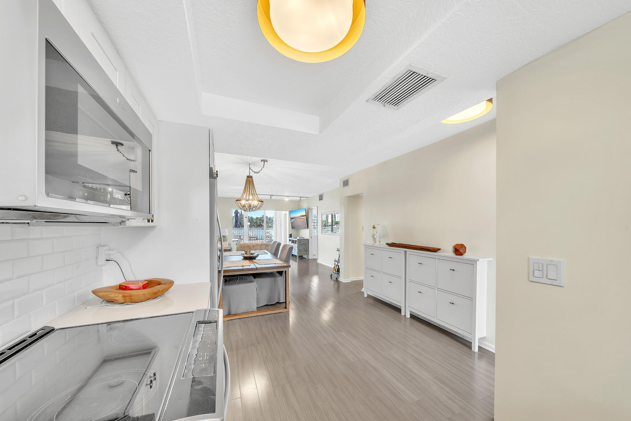 711 Northeast Harbour Terrace, Unit 3090 Boca Raton, FL 33431 - Photo 48 of 53 a kitchen with cabinets and wooden floor