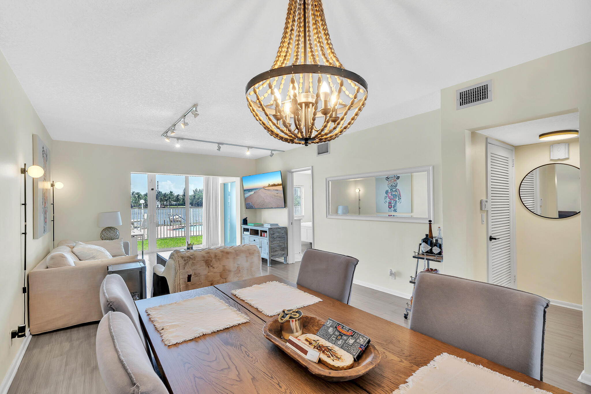 711 Northeast Harbour Terrace, Unit 3090 Boca Raton, FL 33431 - Photo 7 of 53 a living room with furniture a rug and a large window