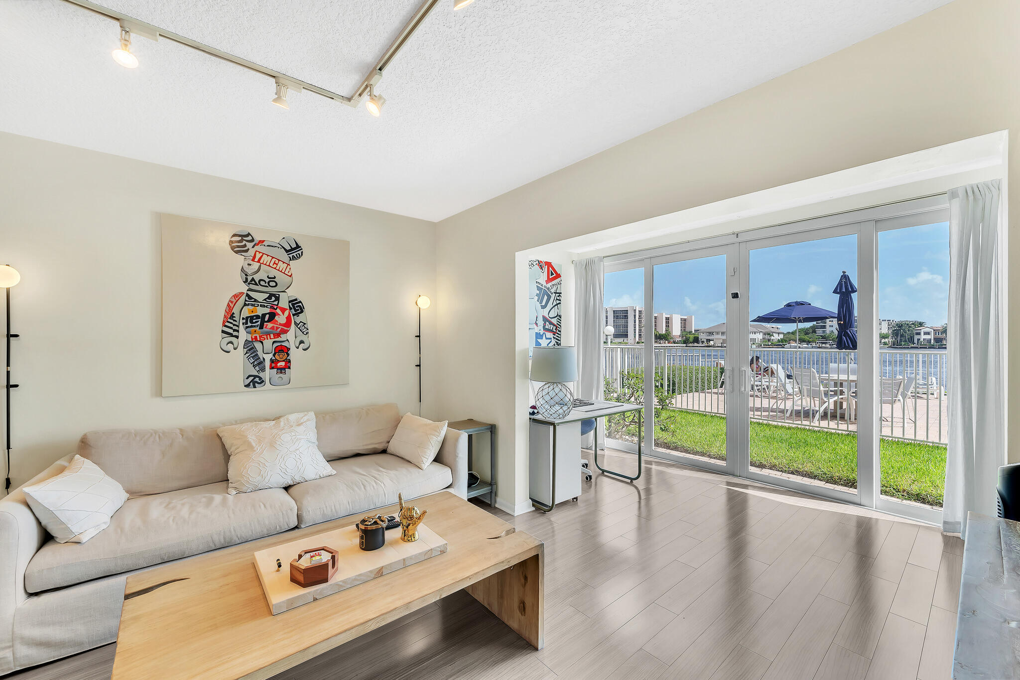 711 Northeast Harbour Terrace, Unit 3090 Boca Raton, FL 33431 - Photo 8 of 53 a living room with furniture and a large window
