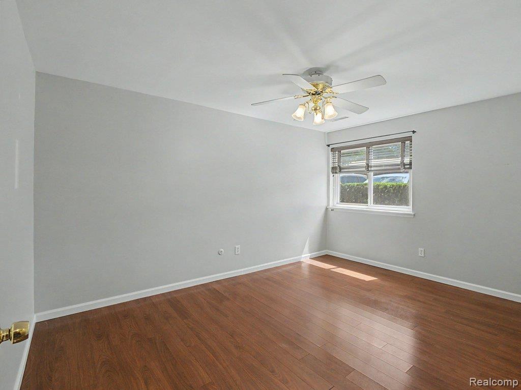 1974 Klingensmith Road, Unit 4 Bloomfield Hills, MI 48302 - Photo 13 of 35 Room with wood-finish flooring, light gray wall paint, and white trim