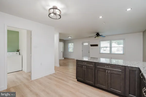 a kitchen with granite countertop a sink and cabinets