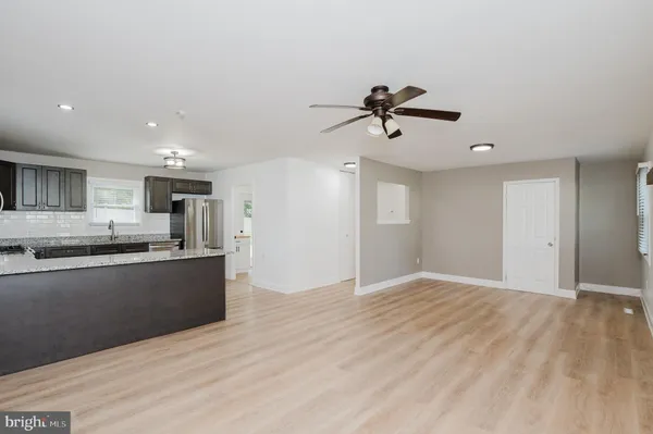 a view of a kitchen with a sink and a refrigerator