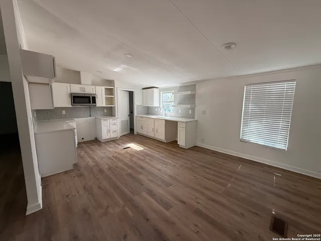 a view of a kitchen with electric appliances