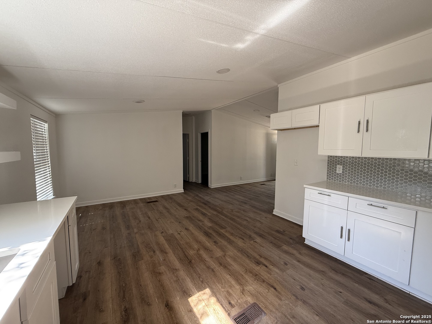 282 Flint Ridge Street Bastrop, TX 78602 - Photo 6 of 12 a view of a kitchen with wooden floor and electronic appliances