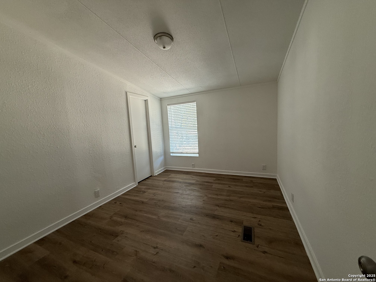 282 Flint Ridge Street Bastrop, TX 78602 - Photo 10 of 12 an empty room with wooden floor and windows