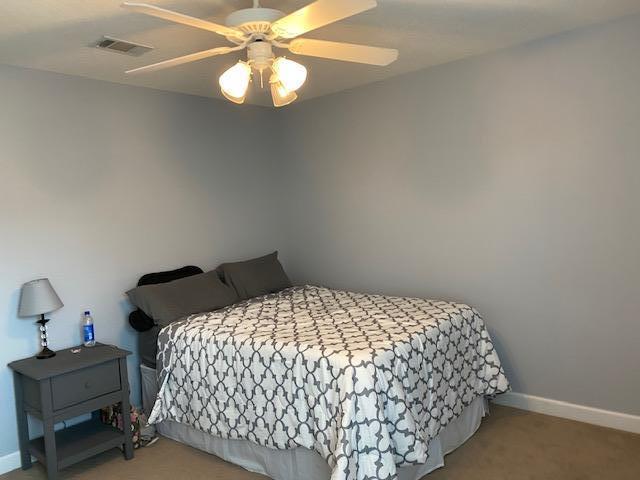 22 3rd Street Shalimar, FL 32579 - Photo 24 of 40 a bedroom with a bed and a chandelier