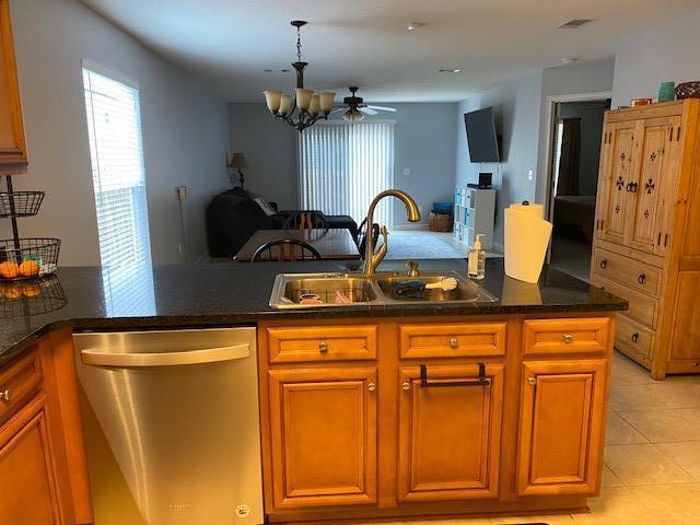 22 3rd Street Shalimar, FL 32579 - Photo 9 of 40 a kitchen with stainless steel appliances granite countertop a refrigerator a sink dishwasher and cabinets with wooden floor