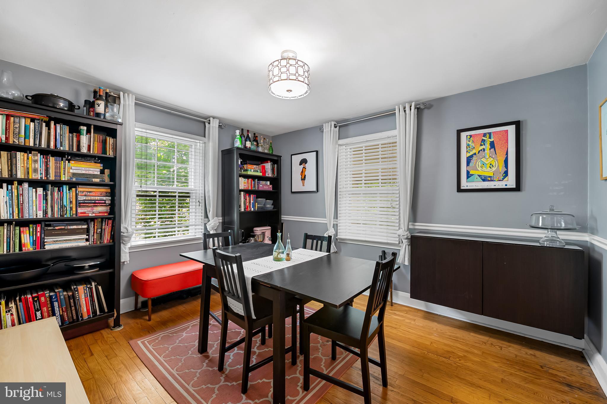 808 Olmstead Road Baltimore, MD 21208 - Photo 7 of 36 a view of a workspace with furniture and a bookshelf