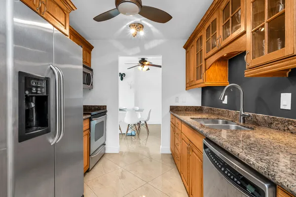 a kitchen with stainless steel appliances granite countertop a sink and a stove