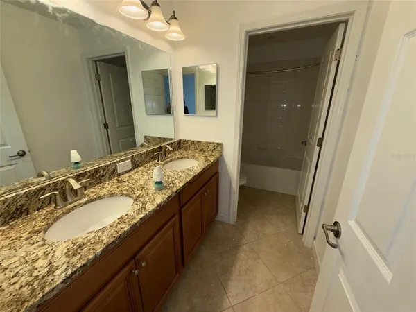a bathroom with a granite countertop sink a mirror and a