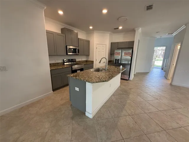 a kitchen with stainless steel appliances granite countertop a stove and a sink