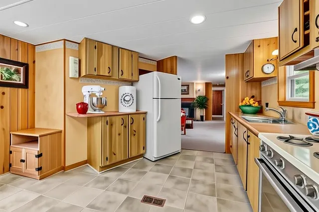 a kitchen with stainless steel appliances granite countertop a stove a sink and a refrigerator