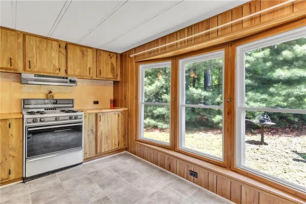 a kitchen with stove and cabinets