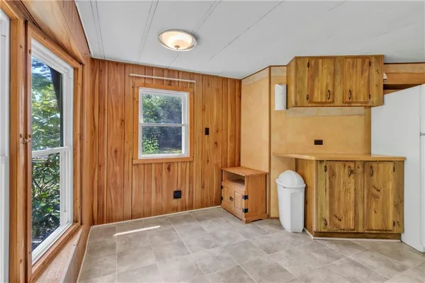 a view of a door with wooden floor and windows