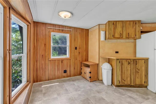 a view of a door with wooden floor and windows