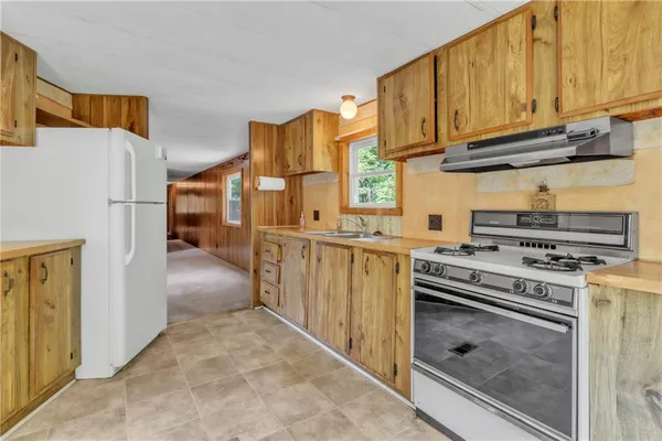 a kitchen with stainless steel appliances granite countertop a stove and a refrigerator