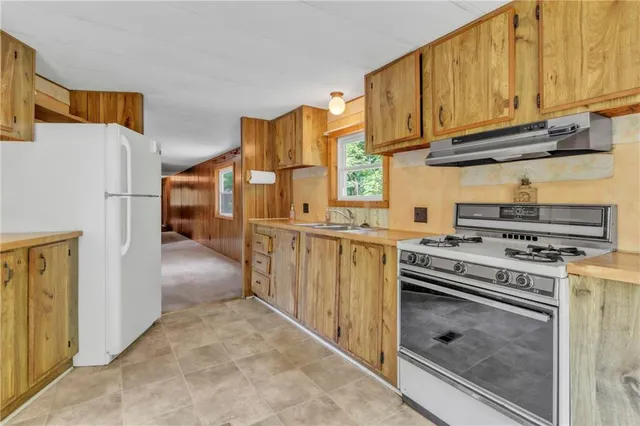 a kitchen with stainless steel appliances granite countertop a stove and a refrigerator