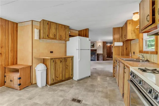 a kitchen with a refrigerator a stove and a cabinets