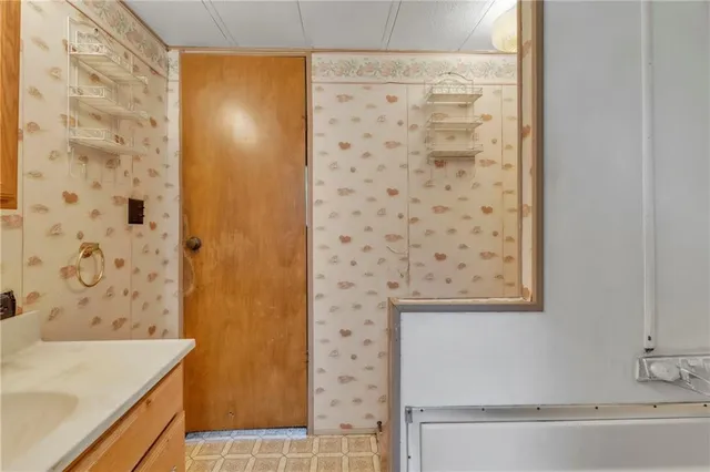 a bathroom with a shower and a sink