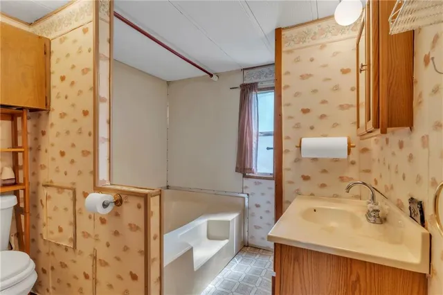 a bathroom with a sink mirror toilet and bathtub