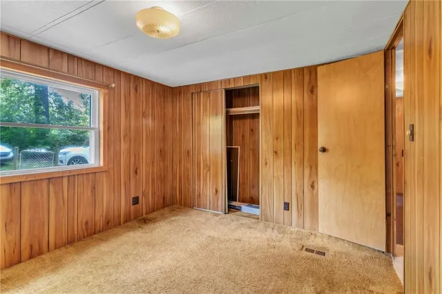 an empty room with windows and closet