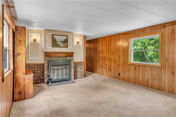 an empty room with furniture and a fireplace