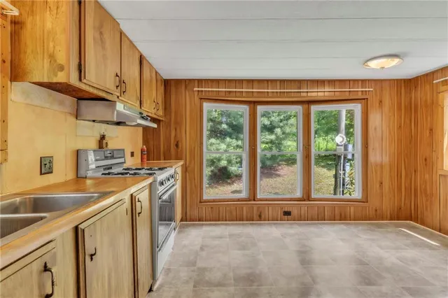 a kitchen that has a sink and a stove