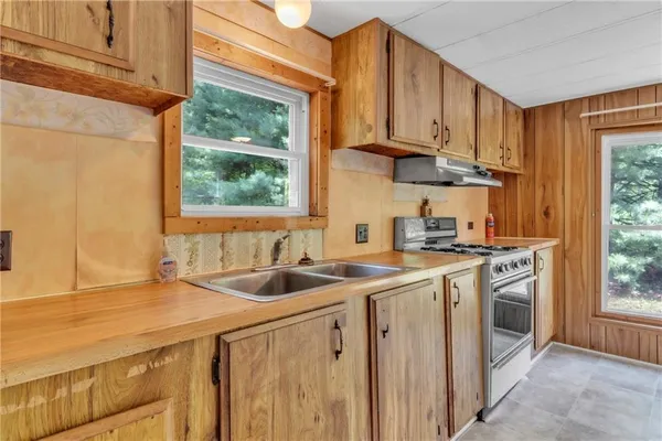 a kitchen with stainless steel appliances granite countertop a sink and a stove