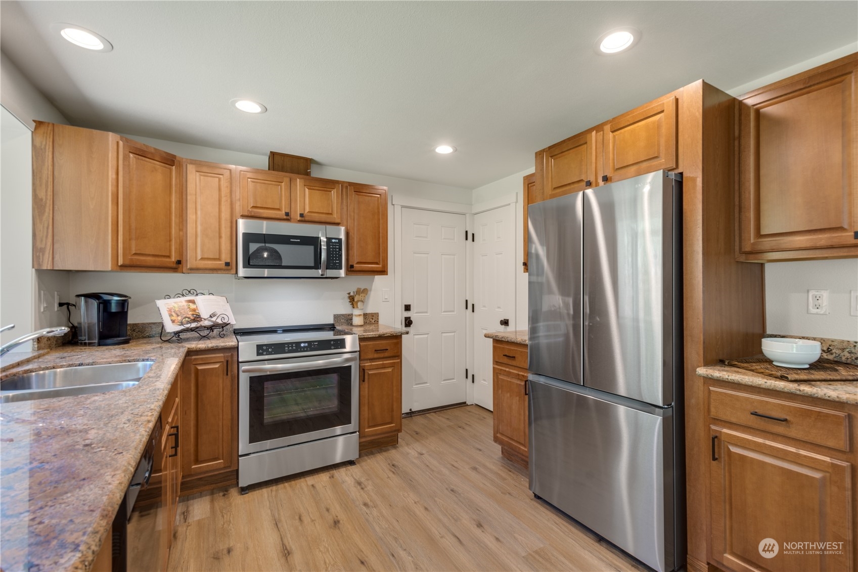 14545 166th Place Southeast Renton, WA 98059 - Photo 11 of 28 a kitchen with stainless steel appliances granite countertop a refrigerator stove and microwave