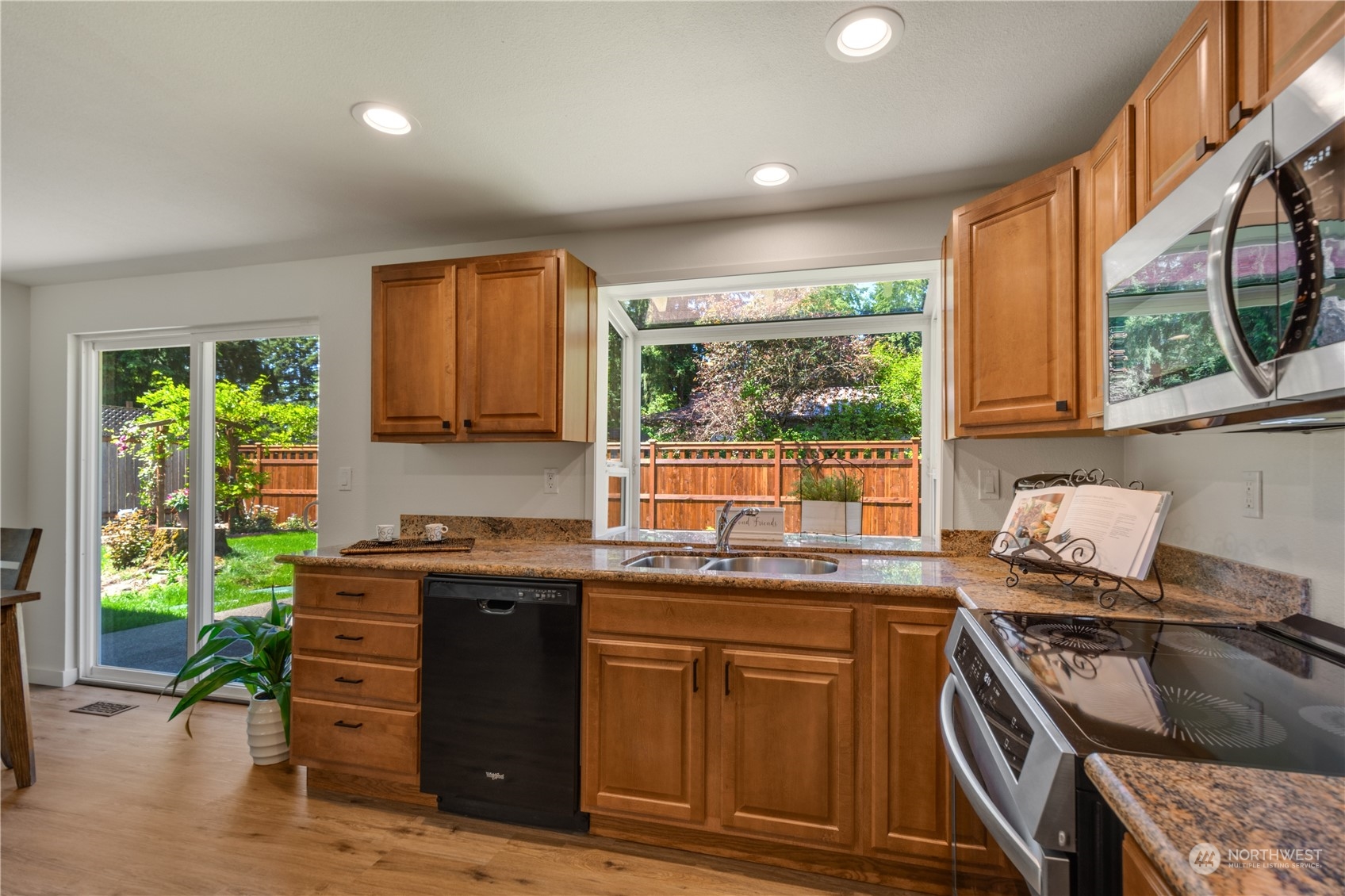 14545 166th Place Southeast Renton, WA 98059 - Photo 12 of 28 a kitchen with stainless steel appliances granite countertop a stove a sink and a microwave