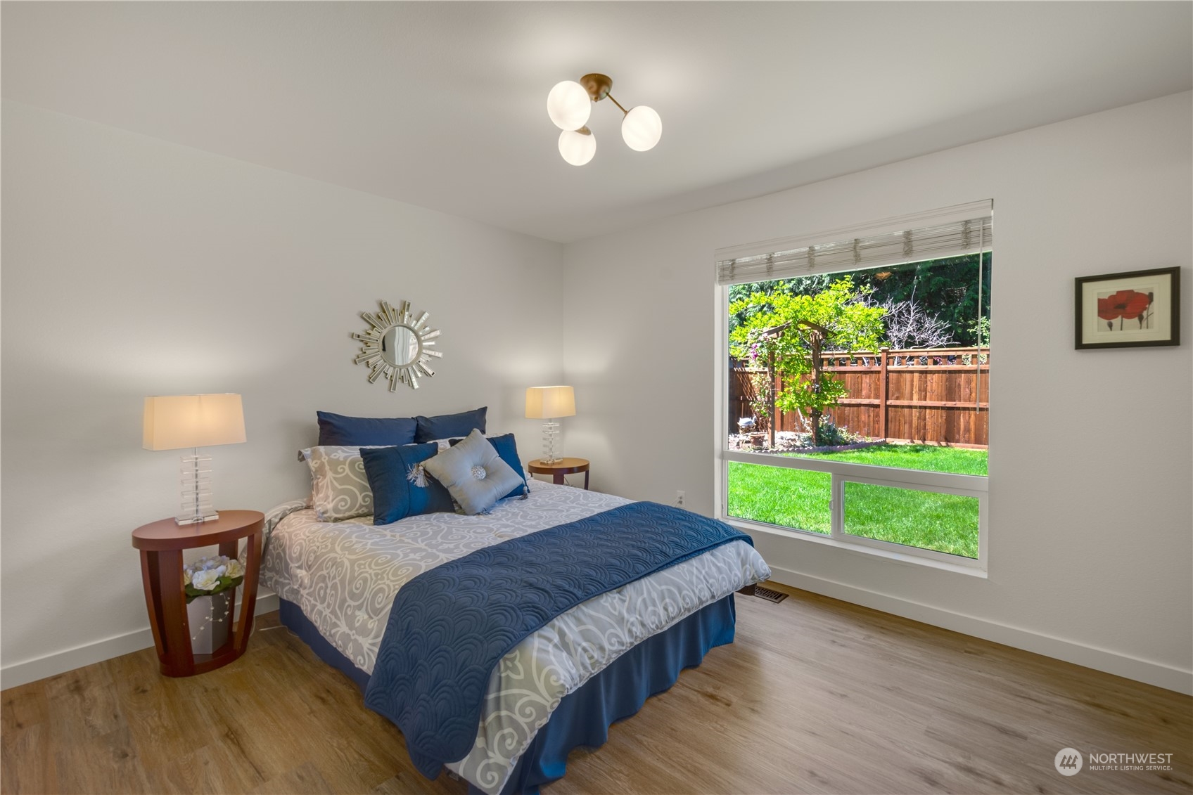 14545 166th Place Southeast Renton, WA 98059 - Photo 13 of 28 a bedroom with a bed and a chandelier