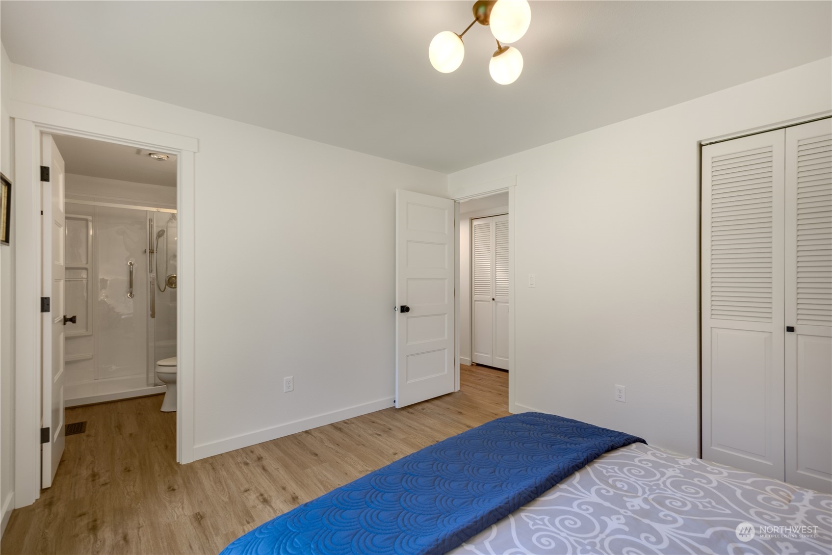 14545 166th Place Southeast Renton, WA 98059 - Photo 15 of 28 a bedroom with wooden floor and a chandelier