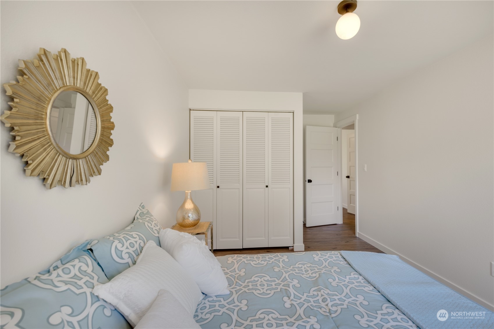 14545 166th Place Southeast Renton, WA 98059 - Photo 18 of 28 a bedroom with a bed and a chandelier