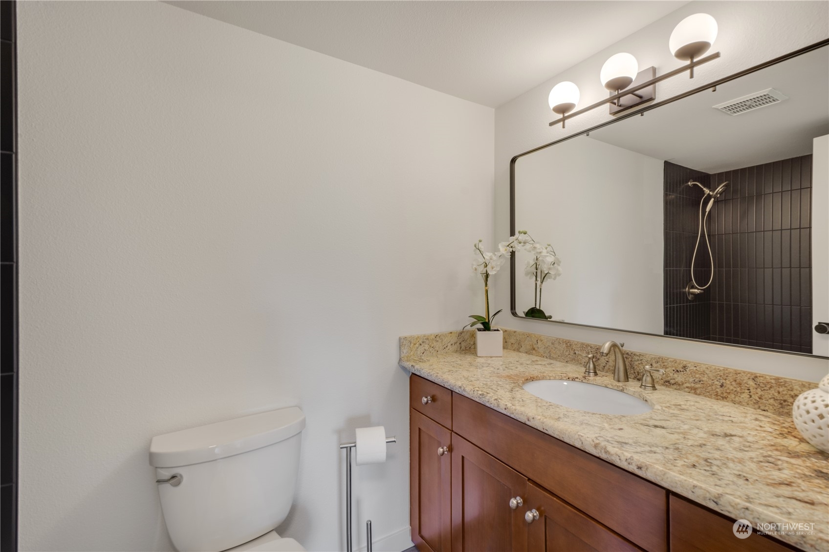 14545 166th Place Southeast Renton, WA 98059 - Photo 19 of 28 a bathroom with a granite countertop sink a toilet and a mirror