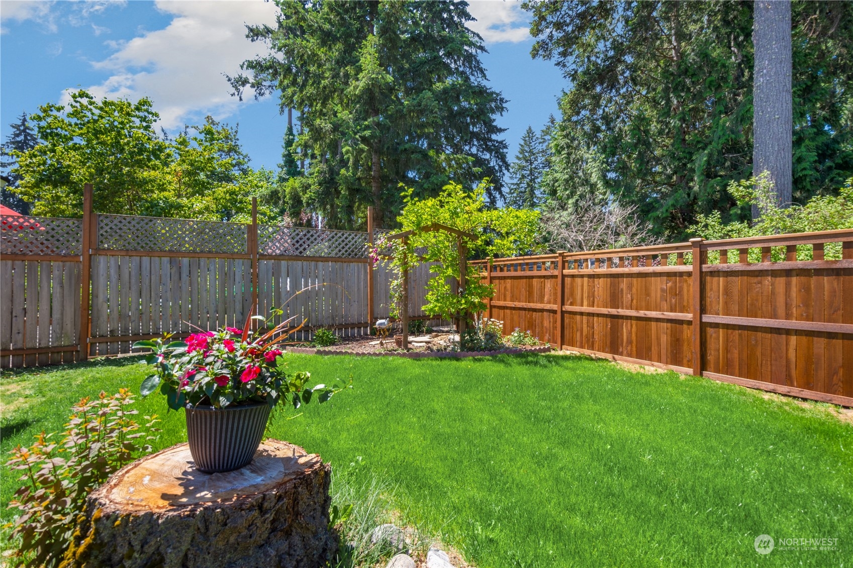 14545 166th Place Southeast Renton, WA 98059 - Photo 26 of 28 a garden with flowers and wooden fence