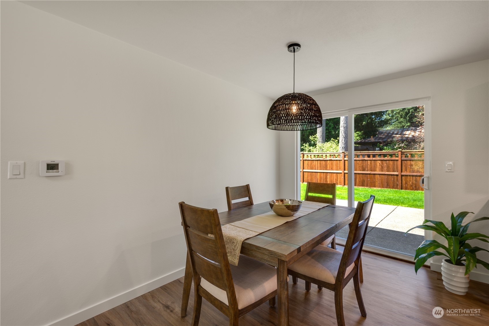 14545 166th Place Southeast Renton, WA 98059 - Photo 7 of 28 a dining room with furniture potted plants and wooden floor