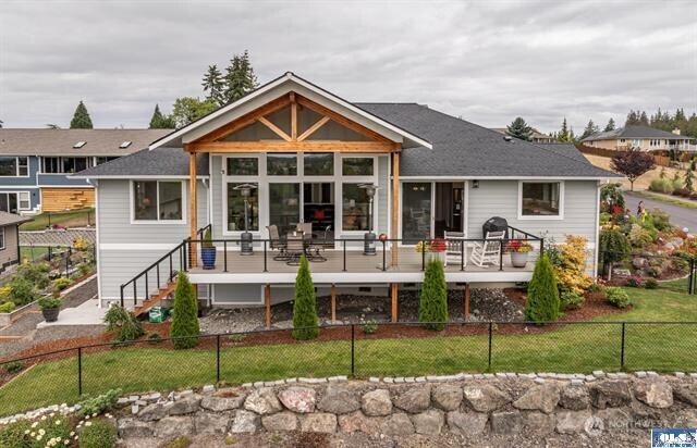 a front view of a house with swimming pool and porch