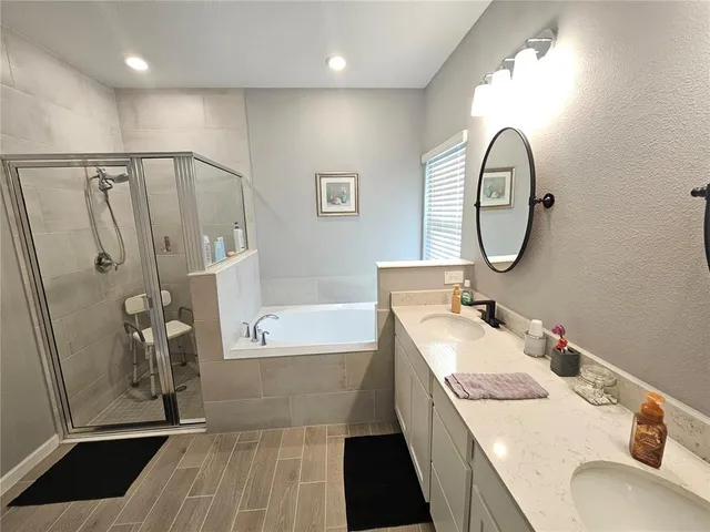 a bathroom with a tub sink and a mirror