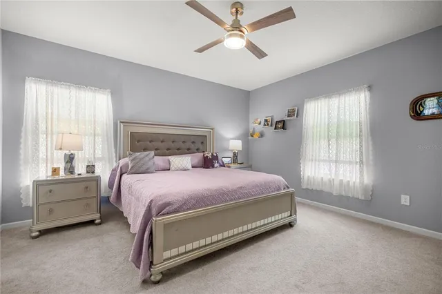 a spacious bedroom with a bed and a chandelier
