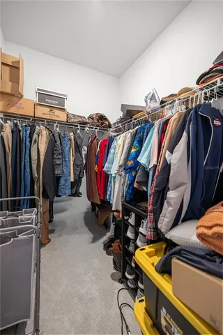 a view of walk in closet with clothes