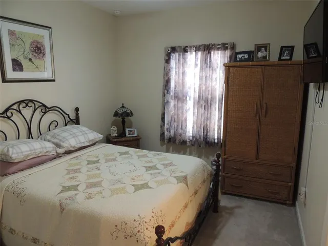 a bedroom with a bed and a dresser