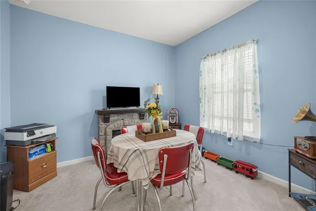 a dining room with furniture and a flat screen tv