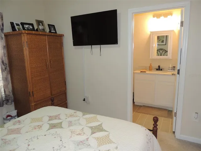 a bedroom with a bed and flat screen tv