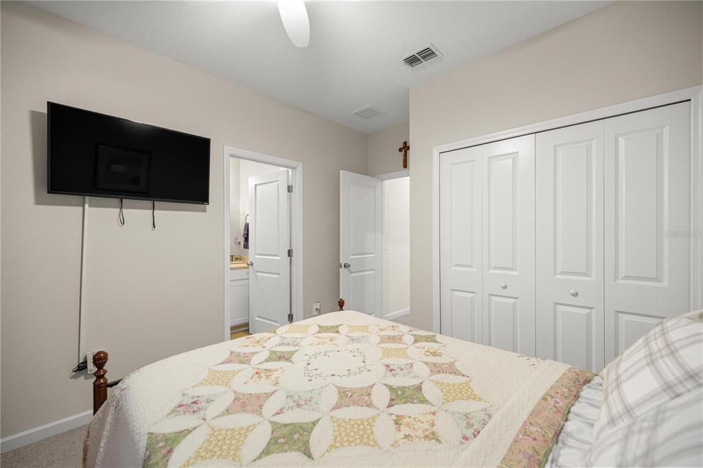 560 Northwest 4th Avenue Williston, FL 32696 - Photo 28 of 31 a bedroom with a bed and a flat screen tv